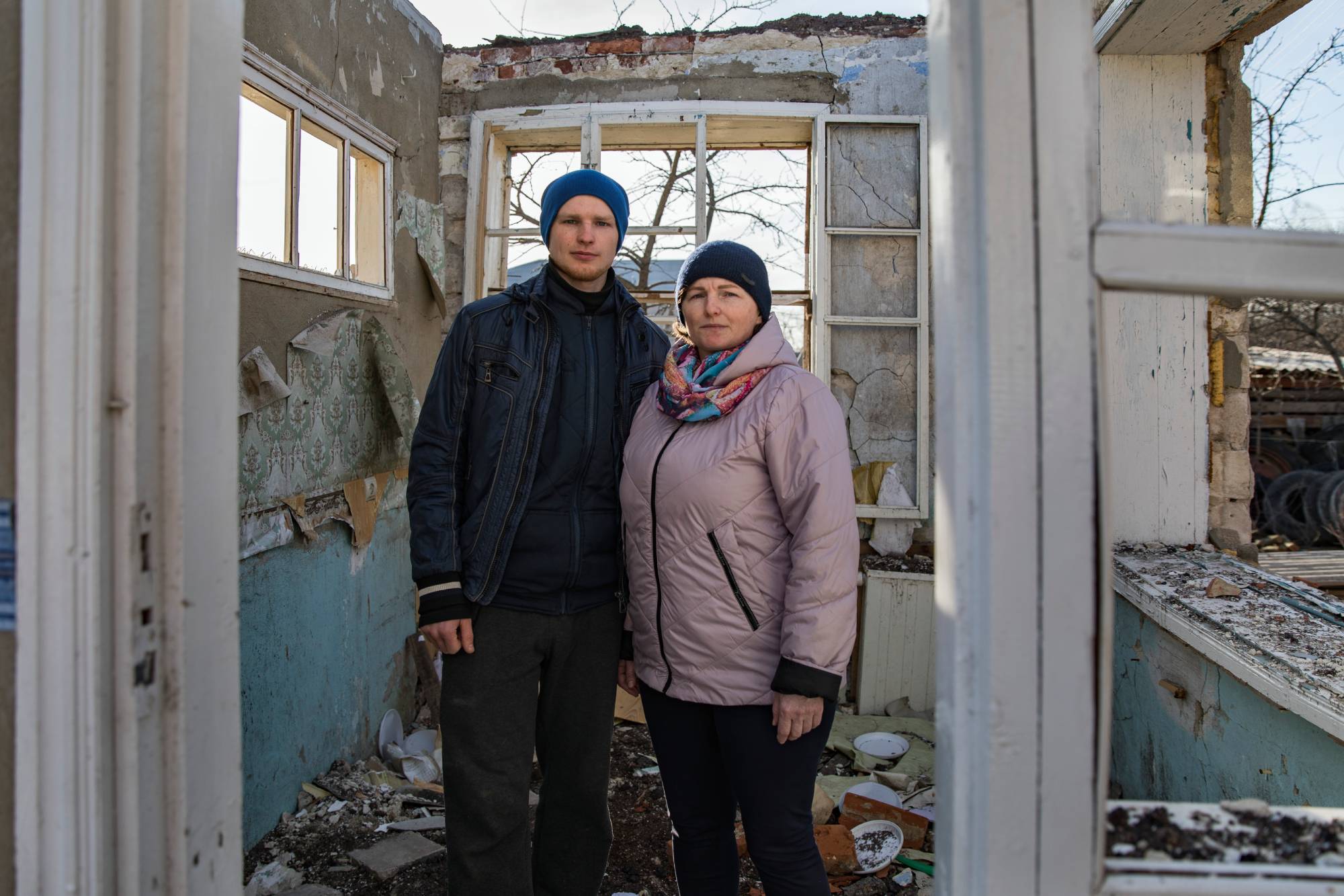 Halyna and her son, Vitali, stand in the remains of their family home which was badly damaged by a missile strike in Vinnytsia, Ukraine.